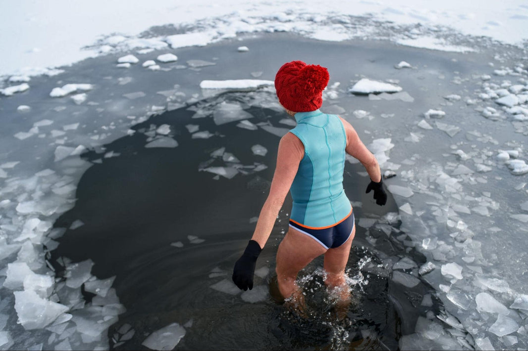 woman doing natural cryotherapy in frozen lake